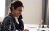 Woman smiling at her computer