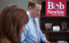 Man standing next to campaign sign