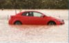 Car half submerged in water