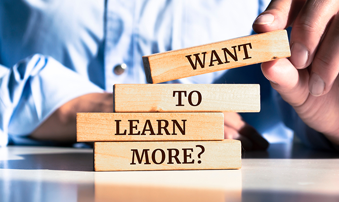 "Want to learn more?" written on wooden blocks